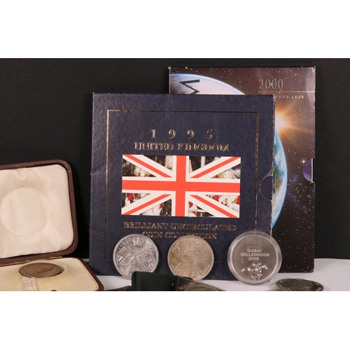 154 - A small collection of commemorative crown and £5 coins together with two medallions and a coin brace... 