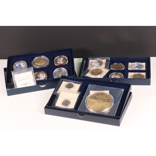 173 - A selection of commemorative collectors coins housed within three fitted boxes to include Winston Ch... 