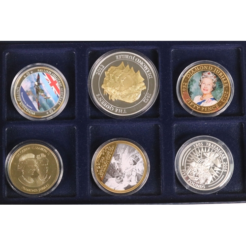 173 - A selection of commemorative collectors coins housed within three fitted boxes to include Winston Ch... 