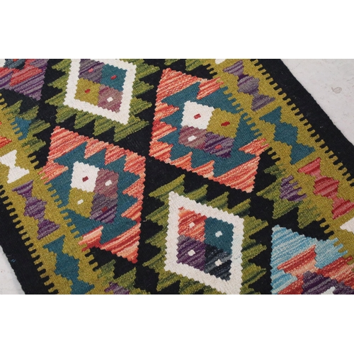 696A - Maimana Kilim runner rug having a woven coloured geometric design. Measures 202 x 69cm.