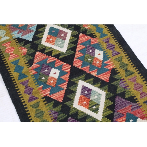 696A - Maimana Kilim runner rug having a woven coloured geometric design. Measures 202 x 69cm.