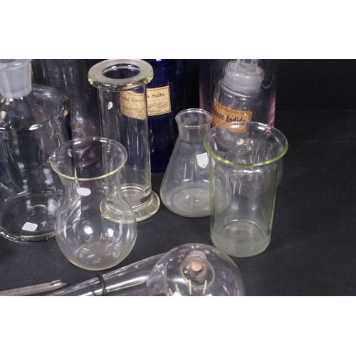 113 - Assortment of vintage chemist items to include glass beakers, bottles, eyebath and equipment, with g... 