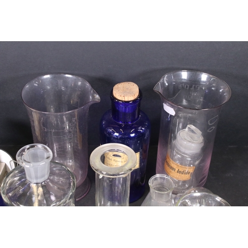 113 - Assortment of vintage chemist items to include glass beakers, bottles, eyebath and equipment, with g... 