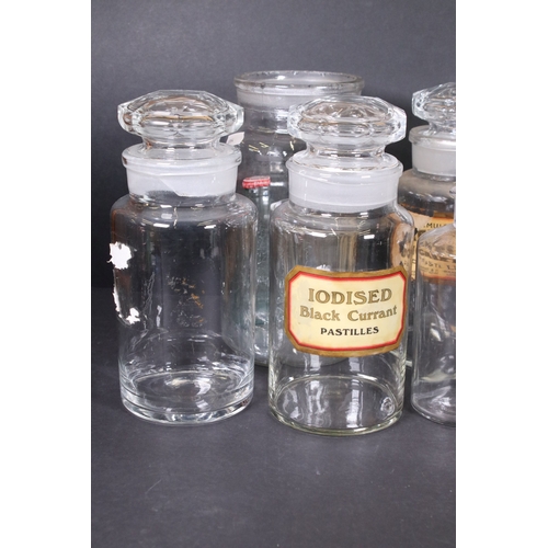 114 - Collection of vintage apothecary glass jars and bottles with original labels and one embossed exampl... 