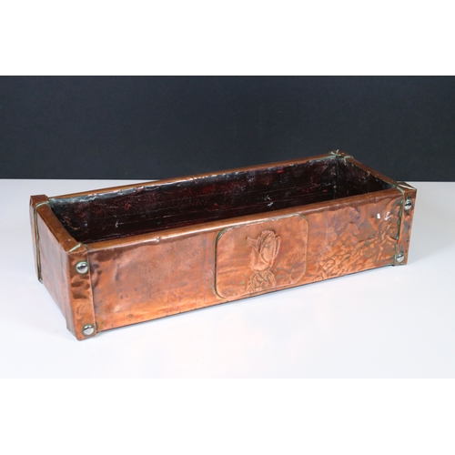 169 - Arts and Crafts copper and oak lined planter, the front decorated with an embossed rose and with stu... 