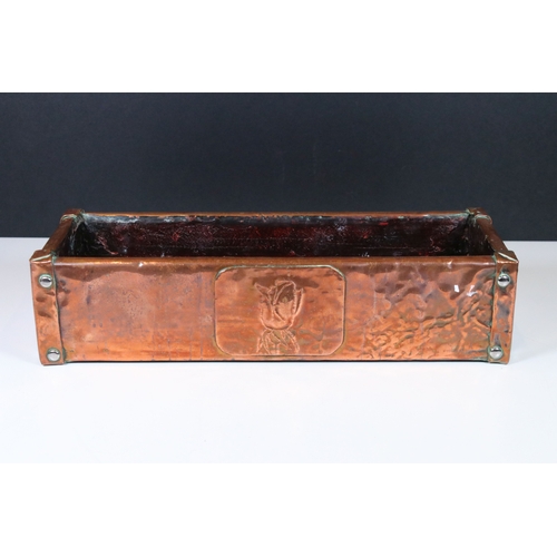 169 - Arts and Crafts copper and oak lined planter, the front decorated with an embossed rose and with stu... 