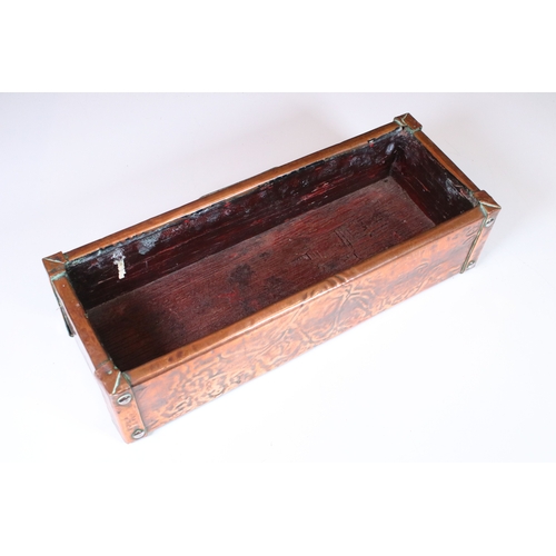 169 - Arts and Crafts copper and oak lined planter, the front decorated with an embossed rose and with stu... 