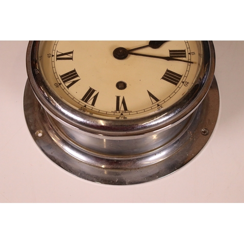 188 - F W Elliot Ltd, London, ships maritime bulk head clock with key, H 8cm, 20cm diameter