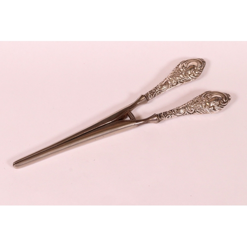 221 - Two sets of early 20th century silver handled glove stretchers with embossed scrolling decoration, C... 