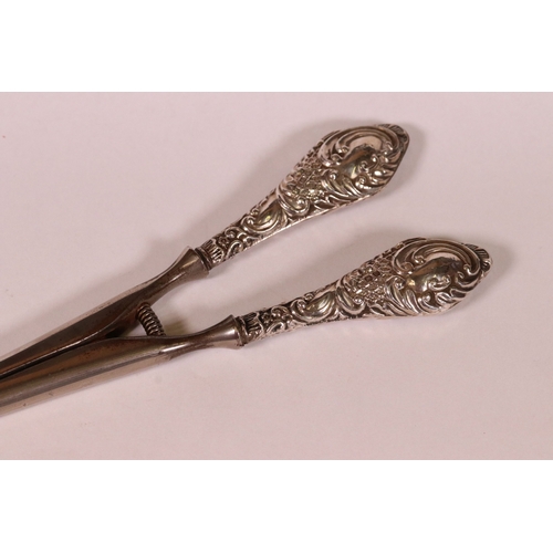 221 - Two sets of early 20th century silver handled glove stretchers with embossed scrolling decoration, C... 