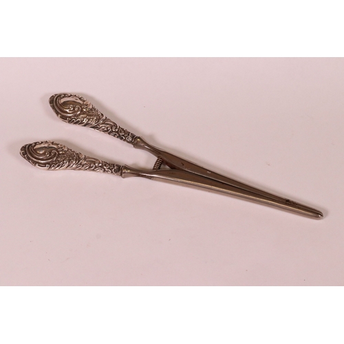 221 - Two sets of early 20th century silver handled glove stretchers with embossed scrolling decoration, C... 