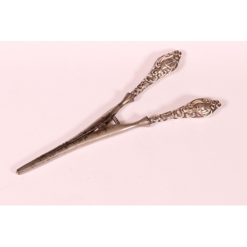 221 - Two sets of early 20th century silver handled glove stretchers with embossed scrolling decoration, C... 