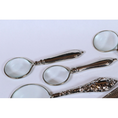 231 - Set of six graduated magnifying glasses with silver plated handles