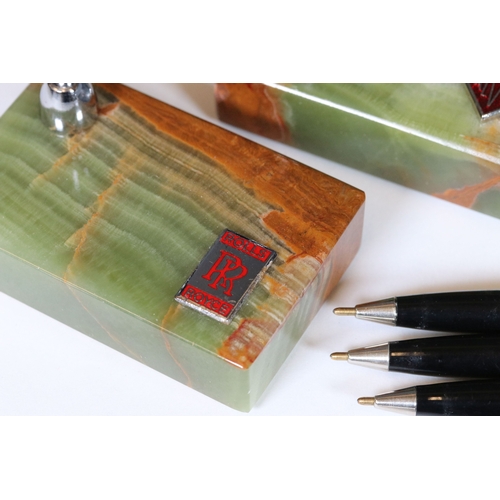 236 - A collection of six desk top pen holders, green agate bases adorned with car makers badges to includ... 