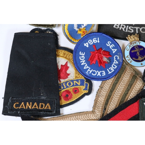 240 - A collection of badges and cloth patches to include Motorcycle, Military and Sports interest.