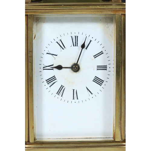 257 - An early 20th century brass cased carriage clock with beveled glass panels and white enamel dial.