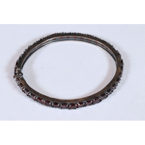 283 - Substantial garnet set bangle