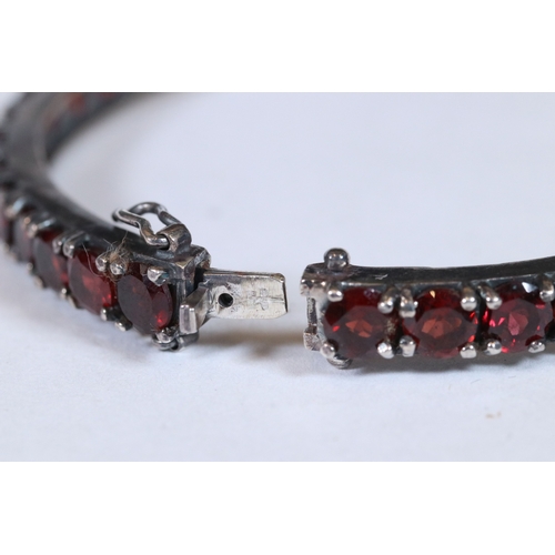 283 - Substantial garnet set bangle