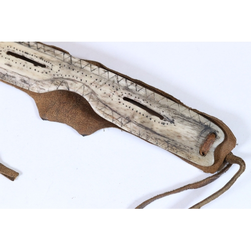 318 - A pair of vintage Inuit snow glasses with scratch work decoration.