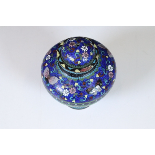 322 - An antique cloisonne lidded jar with floral and butterfly decoration.