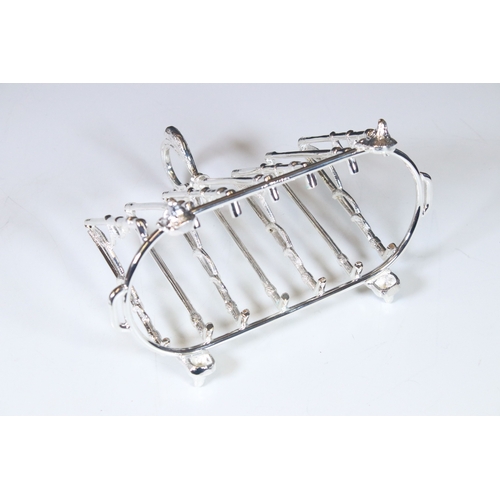 323 - Substantial silver plated country style toast rack with fox mask feet