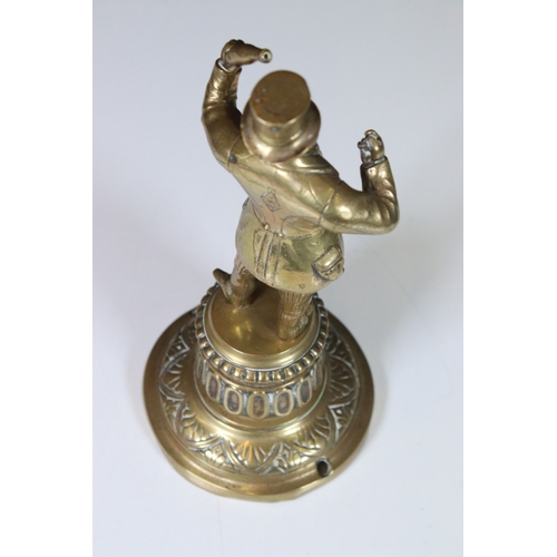 324 - A Victorian brass figure of a gentleman holding a bottle, lozenge mark to the verso.