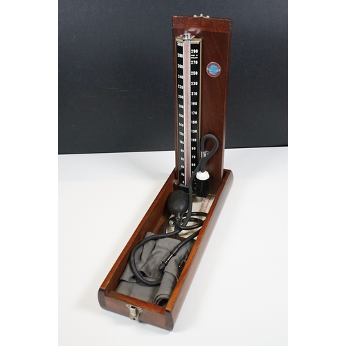 509 - Accoson Sphygmomanometer blood pressure machine in metal case together with an earlier wooden cased ... 