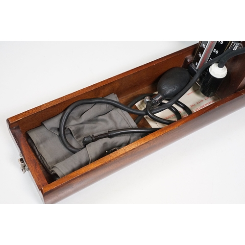 509 - Accoson Sphygmomanometer blood pressure machine in metal case together with an earlier wooden cased ... 