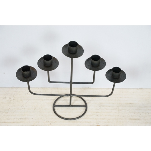 513 - Three 20th century black metal candlesticks, tallest 51.5cm