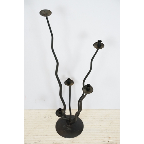 513 - Three 20th century black metal candlesticks, tallest 51.5cm