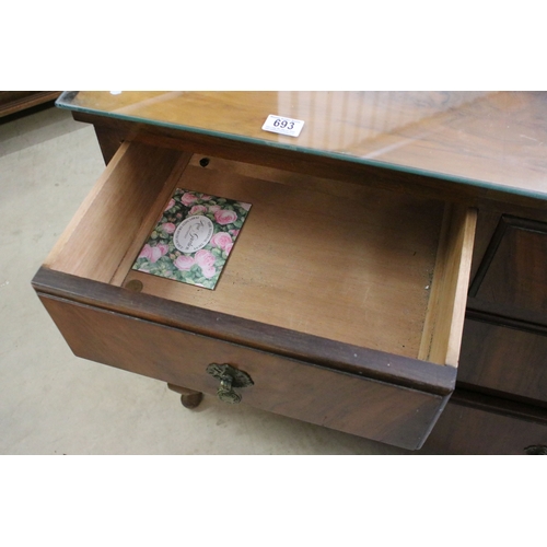 693 - 20th century veneer chest of drawers with glass top cover comprising of two short and three long low... 