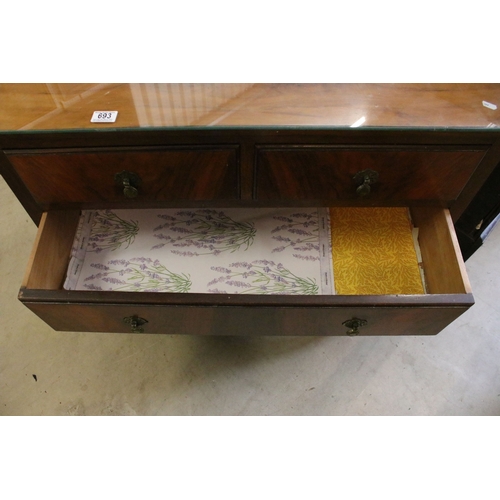 693 - 20th century veneer chest of drawers with glass top cover comprising of two short and three long low... 