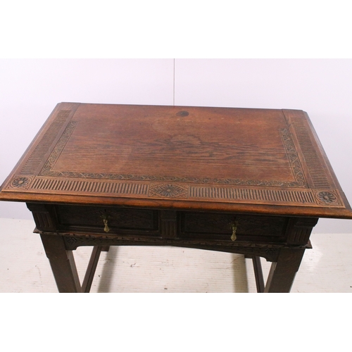 705 - Early 20th century carved top and front oak table with two drawers, H 76cm, W 93cm, D 53cm