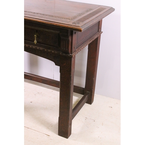 705 - Early 20th century carved top and front oak table with two drawers, H 76cm, W 93cm, D 53cm