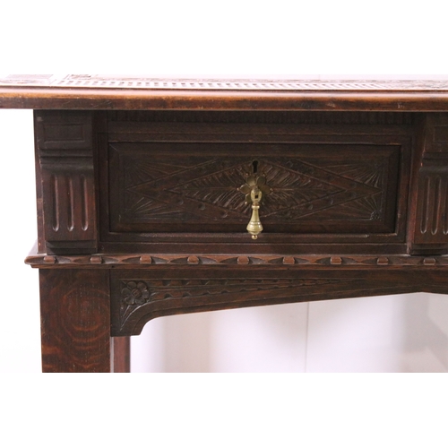 705 - Early 20th century carved top and front oak table with two drawers, H 76cm, W 93cm, D 53cm