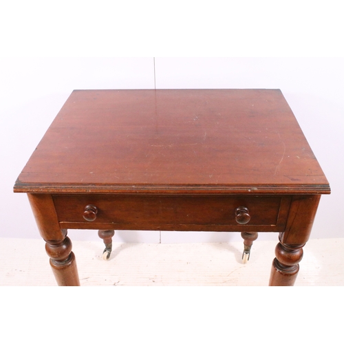 708 - Small single drawer mahogany table with turned legs and casters, H 75cm, W 67cm, D 53cm