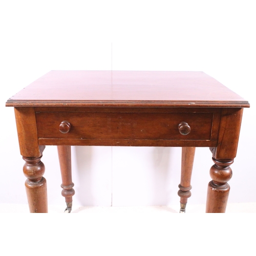 708 - Small single drawer mahogany table with turned legs and casters, H 75cm, W 67cm, D 53cm