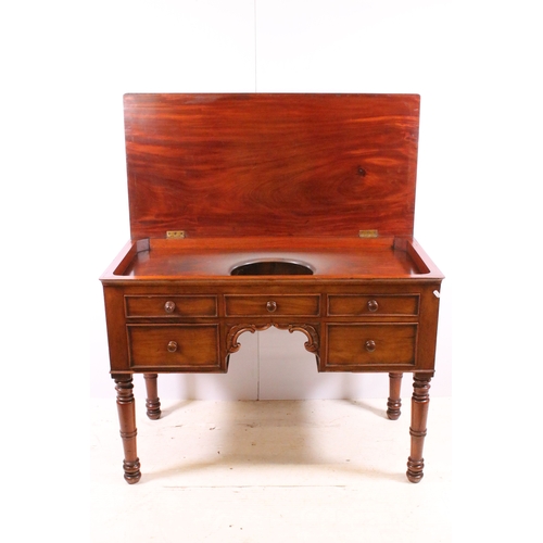 709 - 20th century mahogany dressing wash stand table on turned legs with central carved detail and five d... 