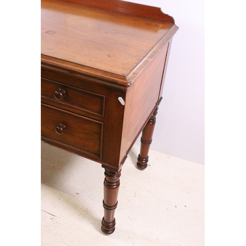 709 - 20th century mahogany dressing wash stand table on turned legs with central carved detail and five d... 