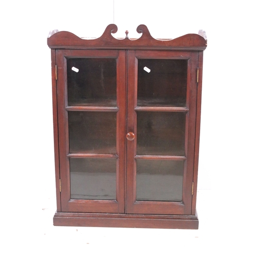 711 - Small mahogany display cabinet bookcase with two front opening glazed doors, H 77c.5m, W 56cm, D 23c... 