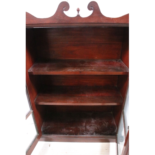 711 - Small mahogany display cabinet bookcase with two front opening glazed doors, H 77c.5m, W 56cm, D 23c... 