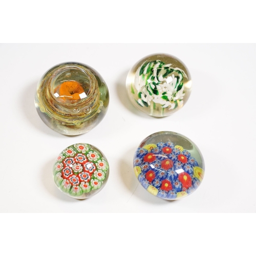 130 - Selection of mixed coloured glass to include Caithness dolphin vase, assorted paperweights, blue gla... 