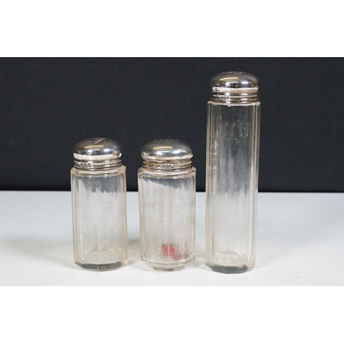 263A - A set of three fully hallmarked silver topped vanity jars together with a fully hallmarked sterling ... 