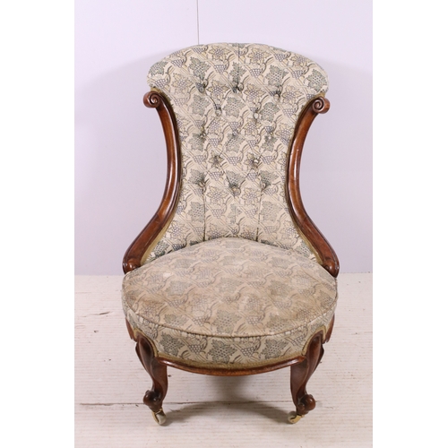 660 - Antique framed nursing chair with button back, scroll carved back and front legs, on casters, H 78cm