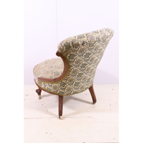 660 - Antique framed nursing chair with button back, scroll carved back and front legs, on casters, H 78cm