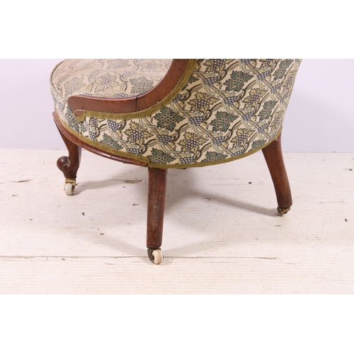 660 - Antique framed nursing chair with button back, scroll carved back and front legs, on casters, H 78cm