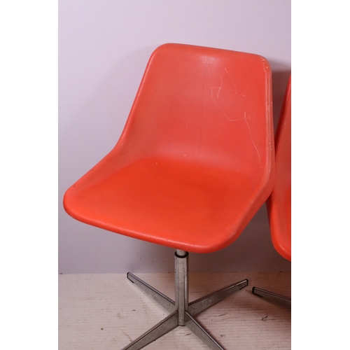 663 - Set of three 1960's Robin Day Design, orange Hille swivel chairs, raised on chrome supports, stamped... 