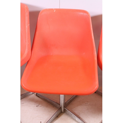 663 - Set of three 1960's Robin Day Design, orange Hille swivel chairs, raised on chrome supports, stamped... 