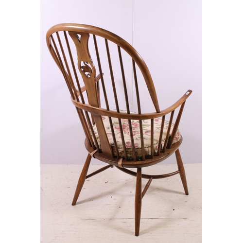 664 - Ercol spindle back Windsor armchair with pierced swan detail back, H 108cm