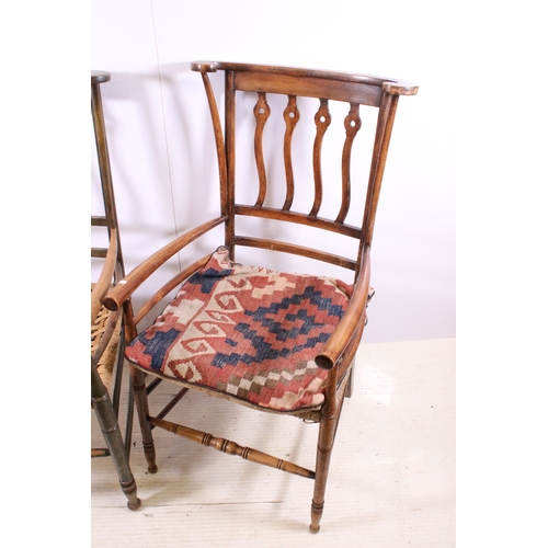 668 - Two Arts and Crafts slat back open arm chairs, curved back rail with four wavy pierced back splats a... 